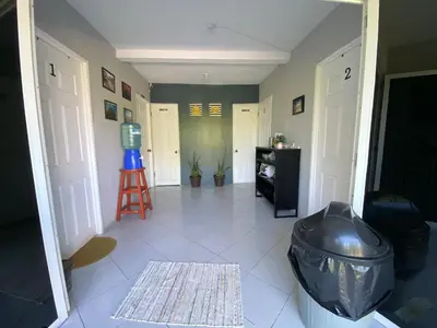 a hallway with a room with a door and a stool at Habitación cerca del aeropuerto #2 in La Paz
