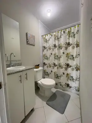a bathroom with a toilet and a shower curtain at Habitación cerca del aeropuerto #2 in La Paz