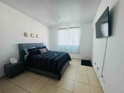 a bedroom with a bed and a flat screen tv at Modern Townhouse AC Wi-Fi full equipped Private in Santa Ana