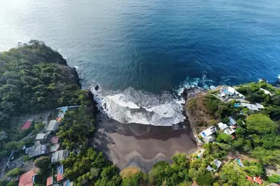 an aerial view of a beach with houses and the ocean at Shalpabay - Rooms in Taquillo