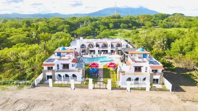 an aerial view of a large white house at Mariposa Reina A in El Tamarindo