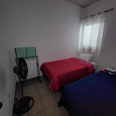 a room with two beds and a fan in it at Apartamento Familiar in Santa Ana