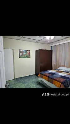a bedroom with a bed and a painting on the wall at Hostal Primaveras nest habitación 3 in Santa Ana