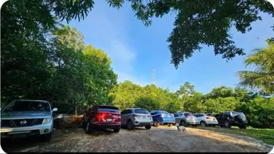 a group of cars parked in a parking lot at Jaco Mizata Beach and River in Las Piedras