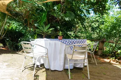 a table with chairs and a blue and white table cloth at Las Cabañitas in San Salvador
