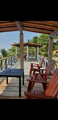 a group of chairs and a bench on a deck at Beach house in la libertad in La Libertad