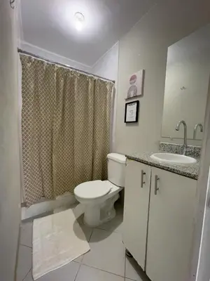 a white bathroom with a toilet and a sink at Habitación cerca del aeropuerto #3 in La Paz