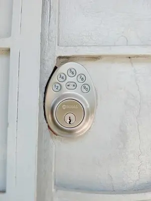 a door with a lock on a white door at Queen Bed in San Salvador