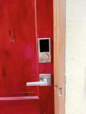 a red door with a safe on the side of it at Queen Bed in San Salvador