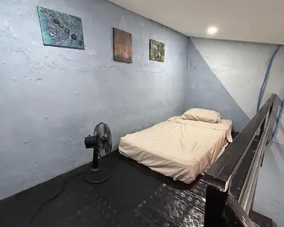 a room with a bed and a fan in it at La Casita de Nataly in Santa Ana
