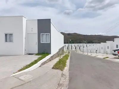 an empty street in front of white buildings at Casa de Reyes in San Miguel