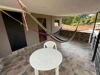a room with a table and a chair and rope at El Mangal 3 B&B in Suchitoto