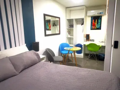 a bedroom with a bed and a table and chairs at Apartamento privado, Miramonte, San Salvador in San Salvador