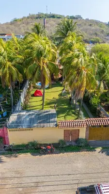 a view of a park with palm trees and a building at Casa DUNA 2 in La Libertad