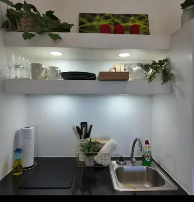a kitchen counter top with a sink and a counter top at Las Terrazas Suites Studio-type apartment in San Salvador