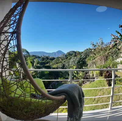 a hammock on a balcony with a view of the mountains at Las Terrazas Suites Studio-type apartment in San Salvador