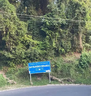 a blue sign on the side of a road at Two Beds San Francisco Chinameca in San Francisco Chinameca