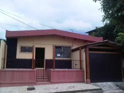 a small house with a red fence in front of it at Casa San Fernando, Ahuachapan in Ahuachapán