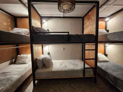 a room with three bunk beds in it at La Mochila Urbana2 in San Salvador