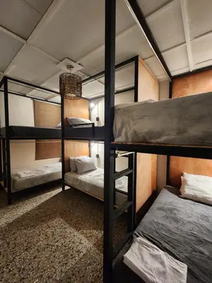 a bedroom with three bunk beds in a room at La Mochila Urbana3 in San Salvador