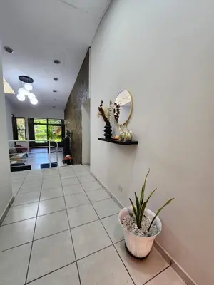 a hallway with a potted plant and a mirror at La Mochila Urbana4 in San Salvador