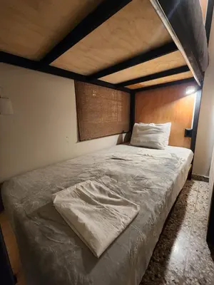 a large bed in a bedroom with a wooden headboard at Mochila Urbana6 in San Salvador