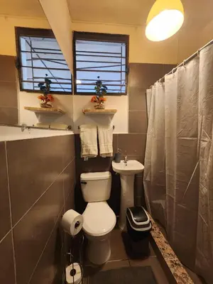 a bathroom with a toilet and a sink at Mochila Urbana6 in San Salvador