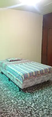 a bedroom with a bed in a room with at San Fernando, Ahuachapan in Ahuachapán