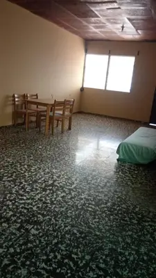 a room with a table and chairs and a bed at San Fernando, Ahuachapan in Ahuachapán