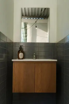 a bathroom with a sink and a mirror at The Duck Dive El Tunco in Tamanique