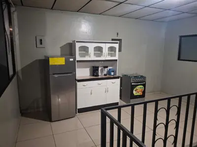 a kitchen with a refrigerator and a counter top at Apartamento in San Salvador