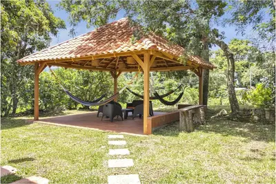 a gazebo with a hammock and a swing at Cozy Bedroom in a coffee farmn in Coatepeque Lake in Santa Ana