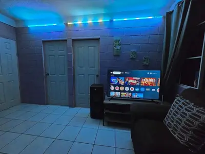a room with a tv in a room with blue lights at the best private apartmet in santa ana for your trip with excelente location in Santa Ana