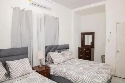 a bedroom with two beds and a dresser at Coco Cabana en Playa San Diego in San Diego