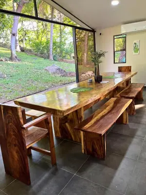 a large wooden table with benches and a window at Game Room • Pool • Fire Pit • Resort Access in Los Cóbanos