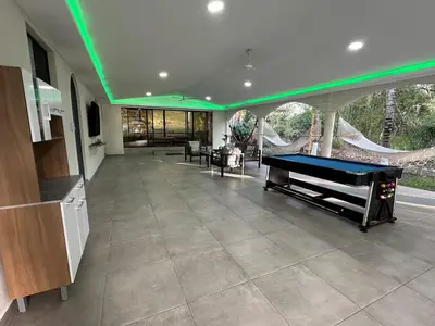 a living room with a pool table in a house at Game Room • Pool • Fire Pit • Resort Access in Los Cóbanos