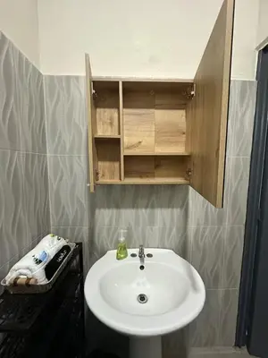 a bathroom with a white sink and a mirror at Pool • Game Room • Fire Pit • Resort Access in Los Cóbanos