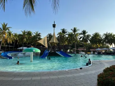 a group of people in a pool at a resort at Pool • Fire Pit • Game Room • Resort Access in Los Cóbanos
