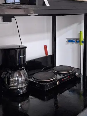 a stove top with a coffee pot on top of it at Villa Sunzal Surf Retreat' in La Libertad