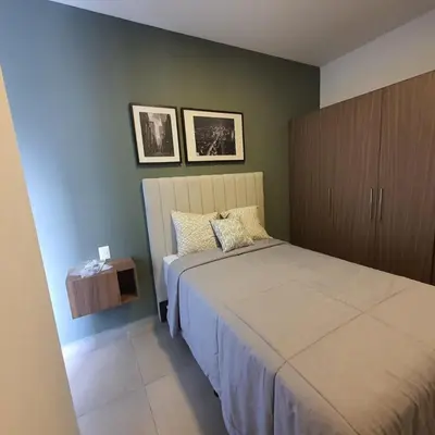 a bedroom with a bed and a wooden cabinet at Tuscania 203 in Zaragoza
