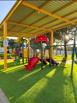 a playground with colorful slides and slides at The small house in Ahuachapán