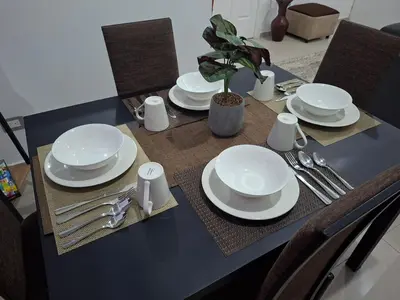 a table with white plates and silverware on it at Nueva San Miguel - Casa Chaparrastique in San Miguel