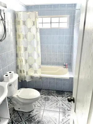 a blue tiled bathroom with a toilet and a tub at Playa El Obispo A La Marea building La Libertad in La Libertad
