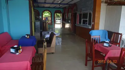a restaurant with two tables and chairs with pink tables at Playa El Obispo F La Libertad Playa El Obispo in La Libertad