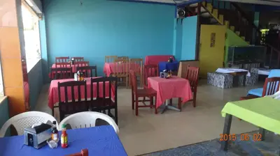 a dining room with tables and chairs and blue walls at Playa El Obipo C La Marea building La Libertad in La Libertad