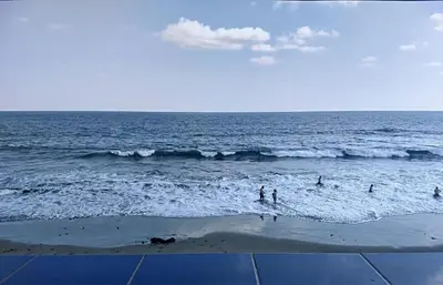 a group of people in the water at the beach at Playa El Obipo C La Marea building La Libertad in La Libertad