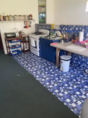 a kitchen with a blue and white tiled floor at Playa El Obispo D La Marea building La Libertad in La Libertad